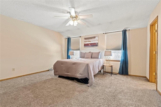 carpeted bedroom with lofted ceiling, ceiling fan, a textured ceiling, and baseboards