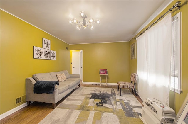 living room with wood-type flooring and a notable chandelier