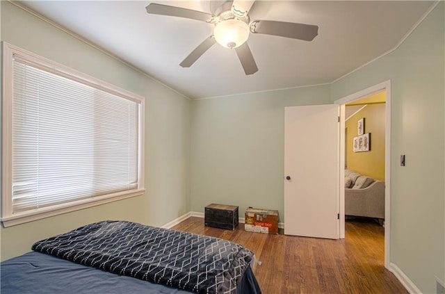 bedroom with ceiling fan and wood-type flooring