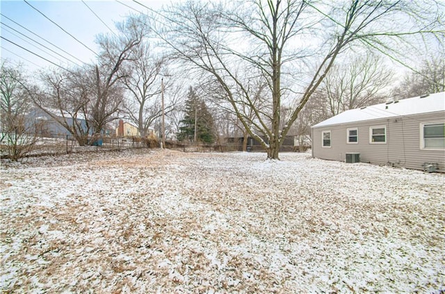 yard layered in snow with central AC unit