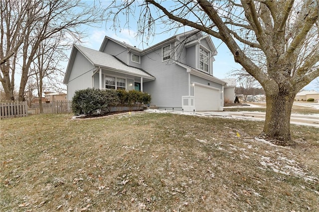 view of side of property with a garage and a lawn