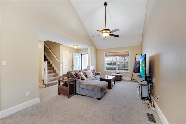 living room featuring high vaulted ceiling, ceiling fan, and light colored carpet