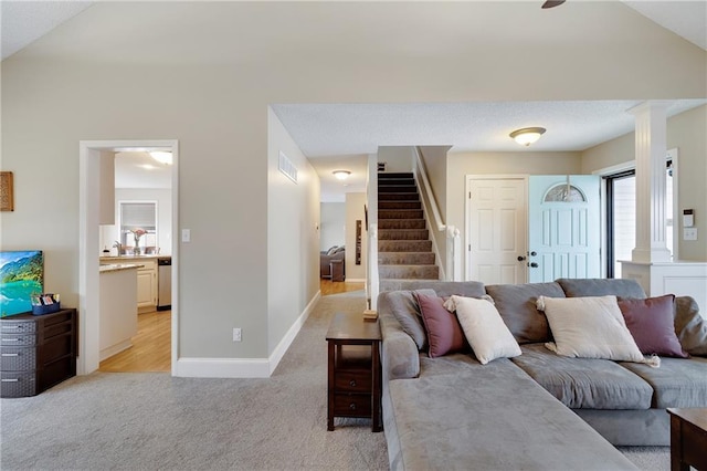 living room featuring light carpet and ornate columns