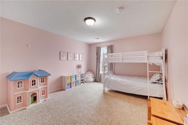 bedroom with carpet floors and a textured ceiling