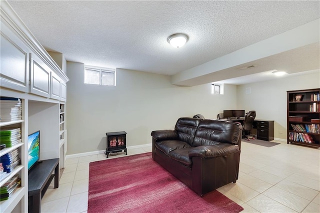 tiled living room with a wood stove and a textured ceiling