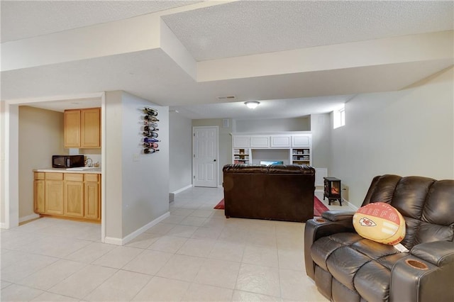 living room featuring light tile patterned floors and a textured ceiling