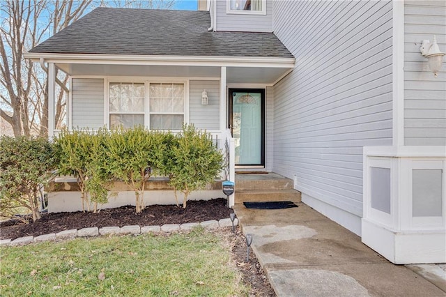 doorway to property with a shingled roof