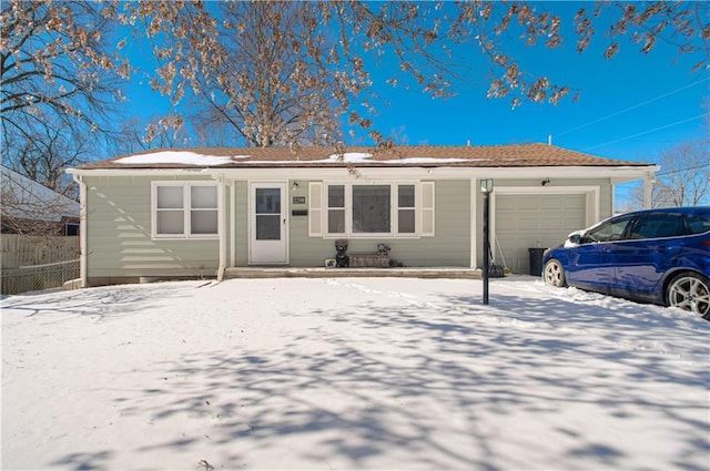 ranch-style home with fence and an attached garage