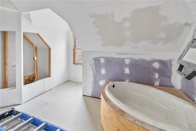 bathroom featuring lofted ceiling