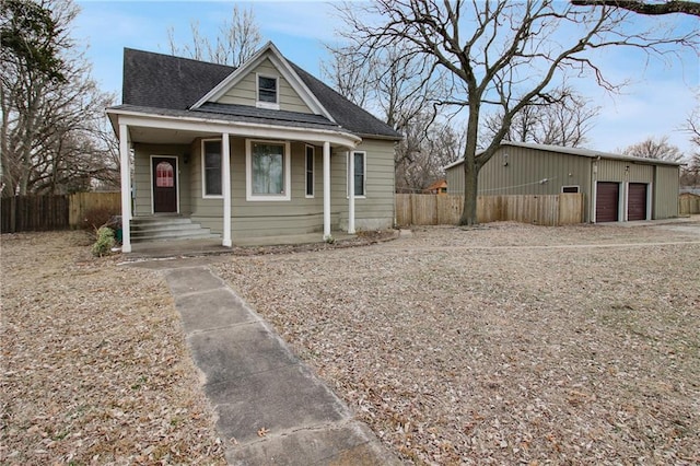 bungalow with covered porch and a garage