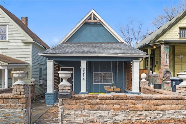 view of front of house featuring covered porch and roof with shingles