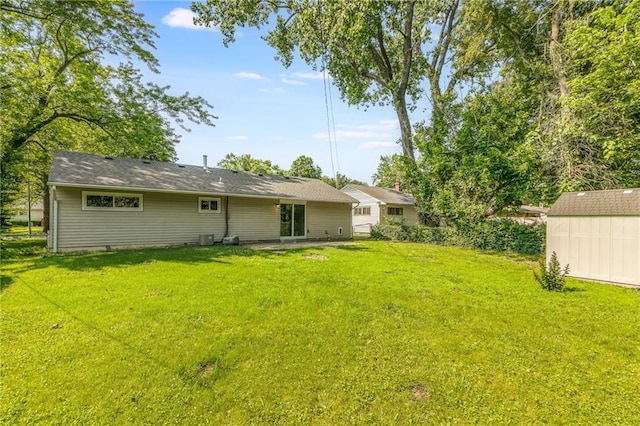 11413 Palmer Ave, Kansas City, MO 64134 - rear view of house featuring a lawn and a storage shed