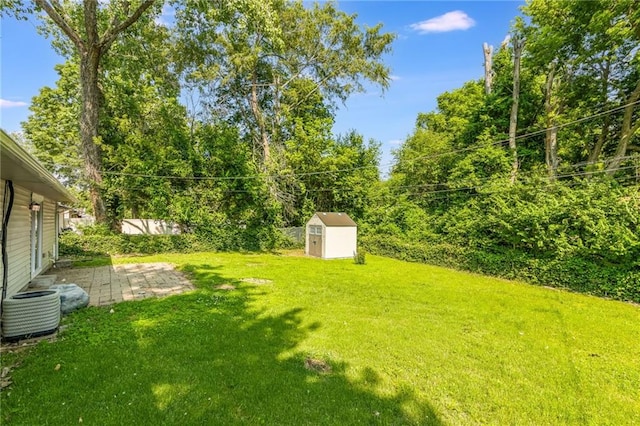 11413 Palmer Ave, Kansas City, MO 64134 - view of green lawn featuring a storage shed and a patio