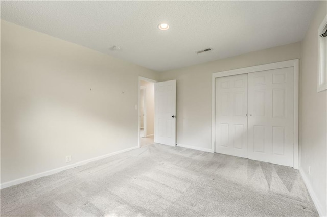 11413 Palmer Ave, Kansas City, MO 64134 - unfurnished bedroom with carpet floors, a textured ceiling, a closet, and recessed lighting