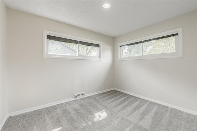 11413 Palmer Ave, Kansas City, MO 64134 - carpeted spare room with a textured ceiling and recessed lighting
