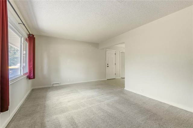 11413 Palmer Ave, Kansas City, MO 64134 - spare room featuring carpet flooring and a textured ceiling