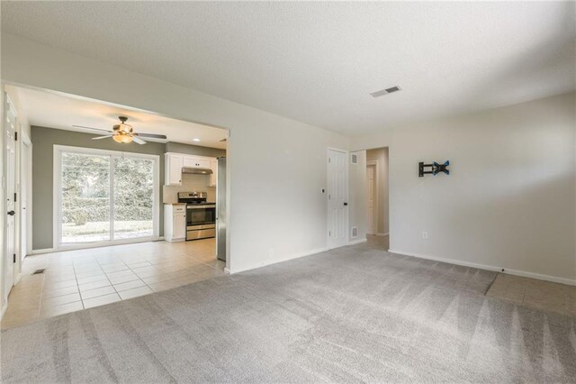 11413 Palmer Ave, Kansas City, MO 64134 - empty room with ceiling fan, light colored carpet, and light tile patterned flooring