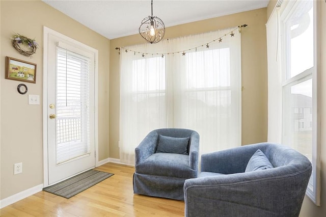 living area with wood finished floors and baseboards