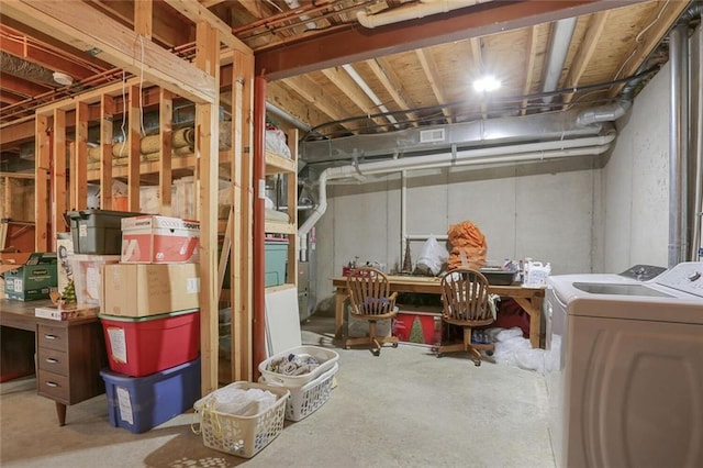 unfinished basement featuring washing machine and dryer