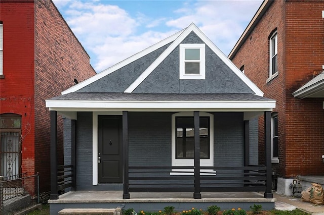 view of front facade with a porch and brick siding