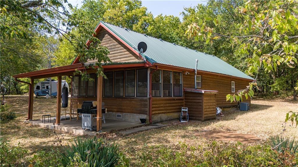 view of side of home featuring a patio area and a sunroom