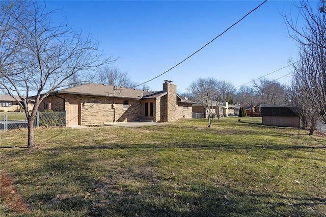 view of yard featuring a storage unit, fence, a patio, and an outbuilding