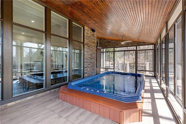 unfurnished sunroom with a jacuzzi, wooden ceiling, and lofted ceiling