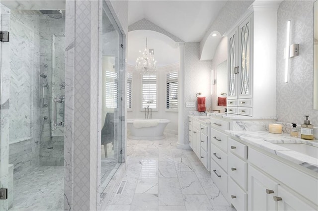 full bath with a marble finish shower, a chandelier, marble finish floor, and vaulted ceiling