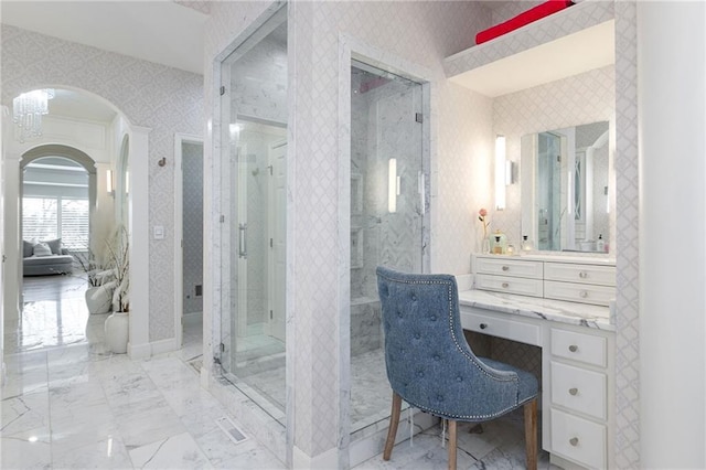 full bathroom featuring marble finish floor, vanity, wallpapered walls, and a shower stall