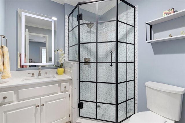 full bathroom featuring a stall shower, toilet, crown molding, and vanity