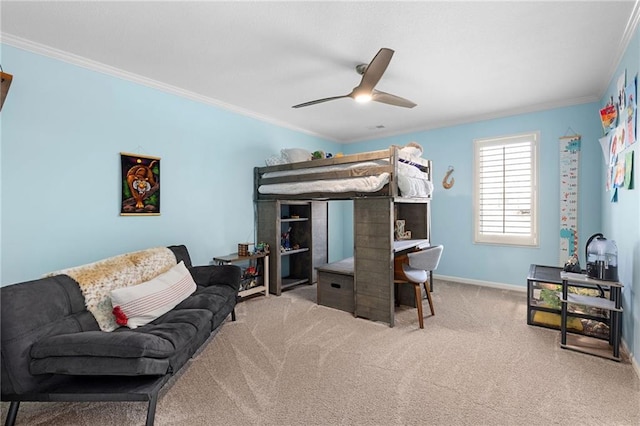 carpeted bedroom featuring ceiling fan, baseboards, and ornamental molding