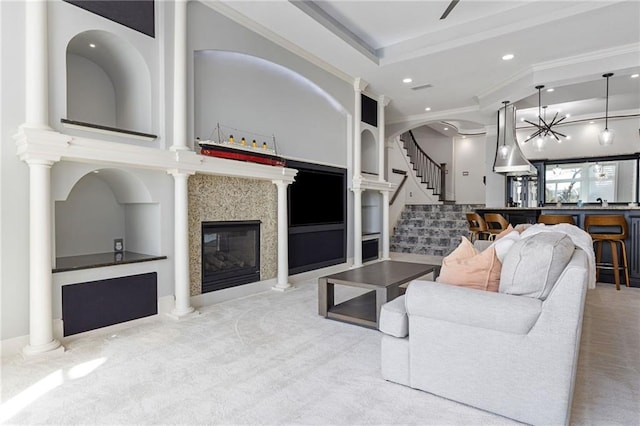 living room with recessed lighting, stairs, a glass covered fireplace, and carpet flooring