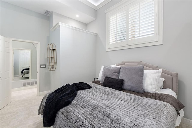 bedroom featuring visible vents, baseboards, and light colored carpet