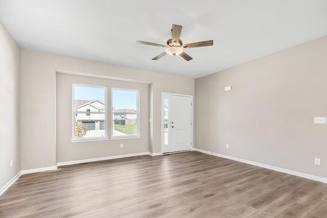 unfurnished room with hardwood / wood-style flooring and ceiling fan