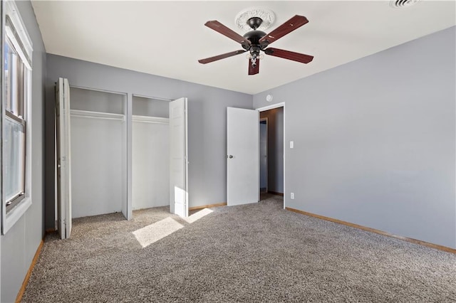 unfurnished bedroom with light carpet, a ceiling fan, baseboards, and a closet