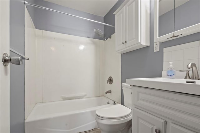 bathroom with washtub / shower combination, decorative backsplash, vanity, and toilet