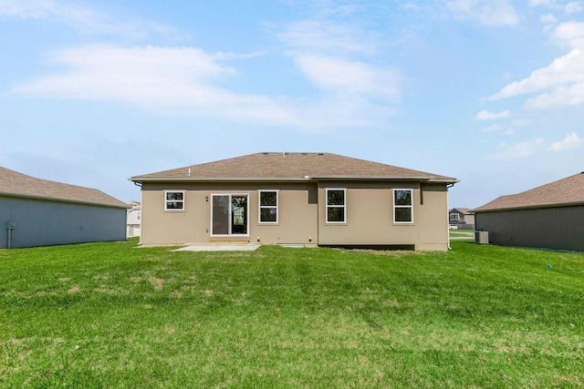 rear view of house featuring a yard