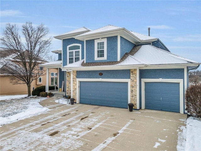 view of front of property with stone siding, concrete driveway, and stucco siding