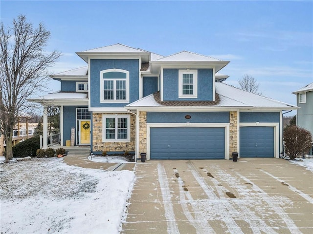 view of front of house featuring concrete driveway, stone siding, and stucco siding