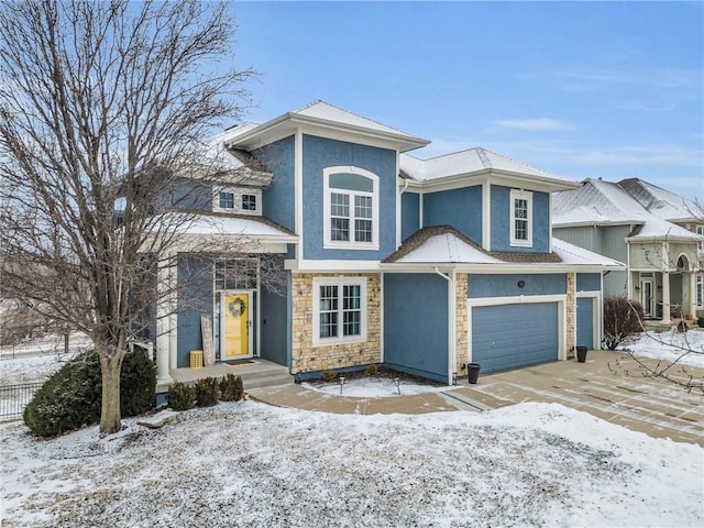 view of front of home featuring stone siding, fence, and stucco siding