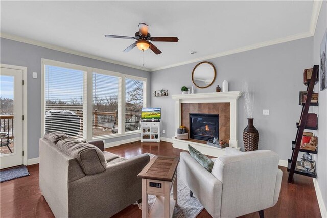 living area featuring a healthy amount of sunlight, crown molding, and wood finished floors