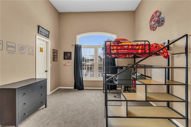 bedroom featuring baseboards and carpet flooring