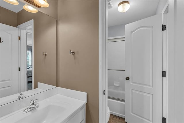 bathroom featuring washtub / shower combination and vanity