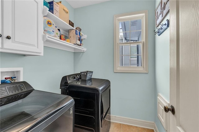 laundry area with independent washer and dryer, tile patterned flooring, cabinet space, and baseboards