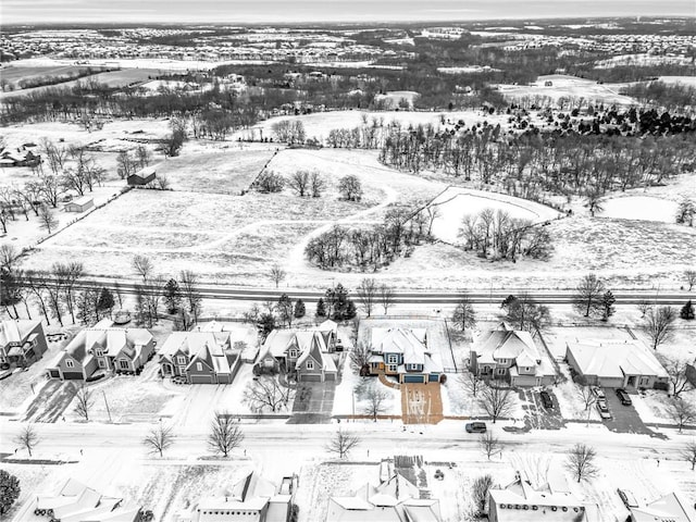 snowy aerial view with a residential view