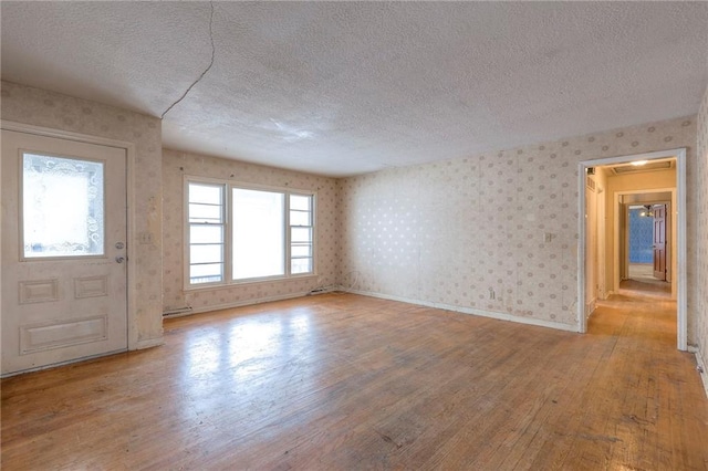 foyer featuring light wood-type flooring and a textured ceiling