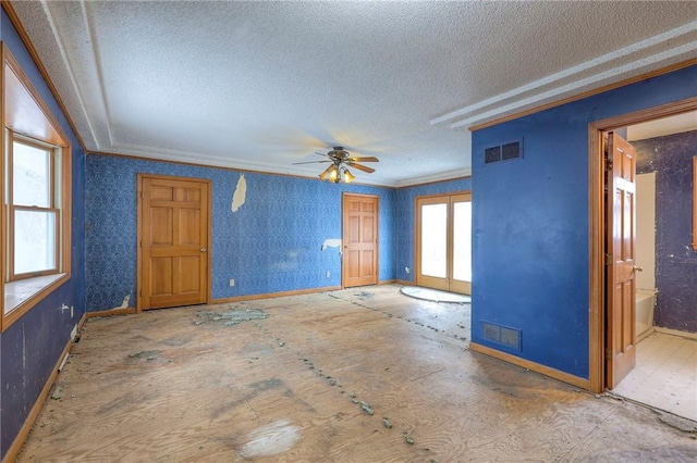 unfurnished room with a textured ceiling, ornamental molding, and ceiling fan