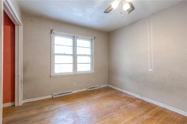 unfurnished room with light wood-type flooring and ceiling fan