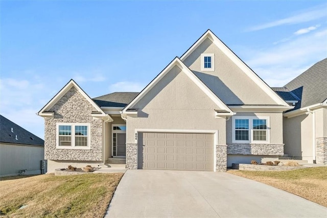 craftsman house featuring concrete driveway, stone siding, stucco siding, an attached garage, and a front yard