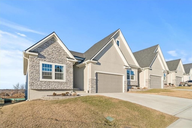 craftsman-style home featuring a garage, stone siding, concrete driveway, and a front yard